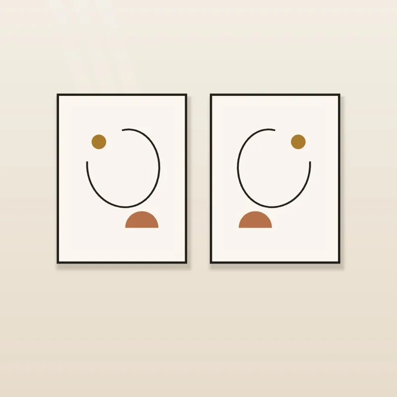 Pair of one-line face drawings in black frames