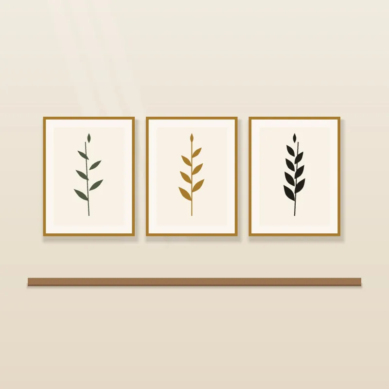 Three botanical leaf prints in slim gold frames